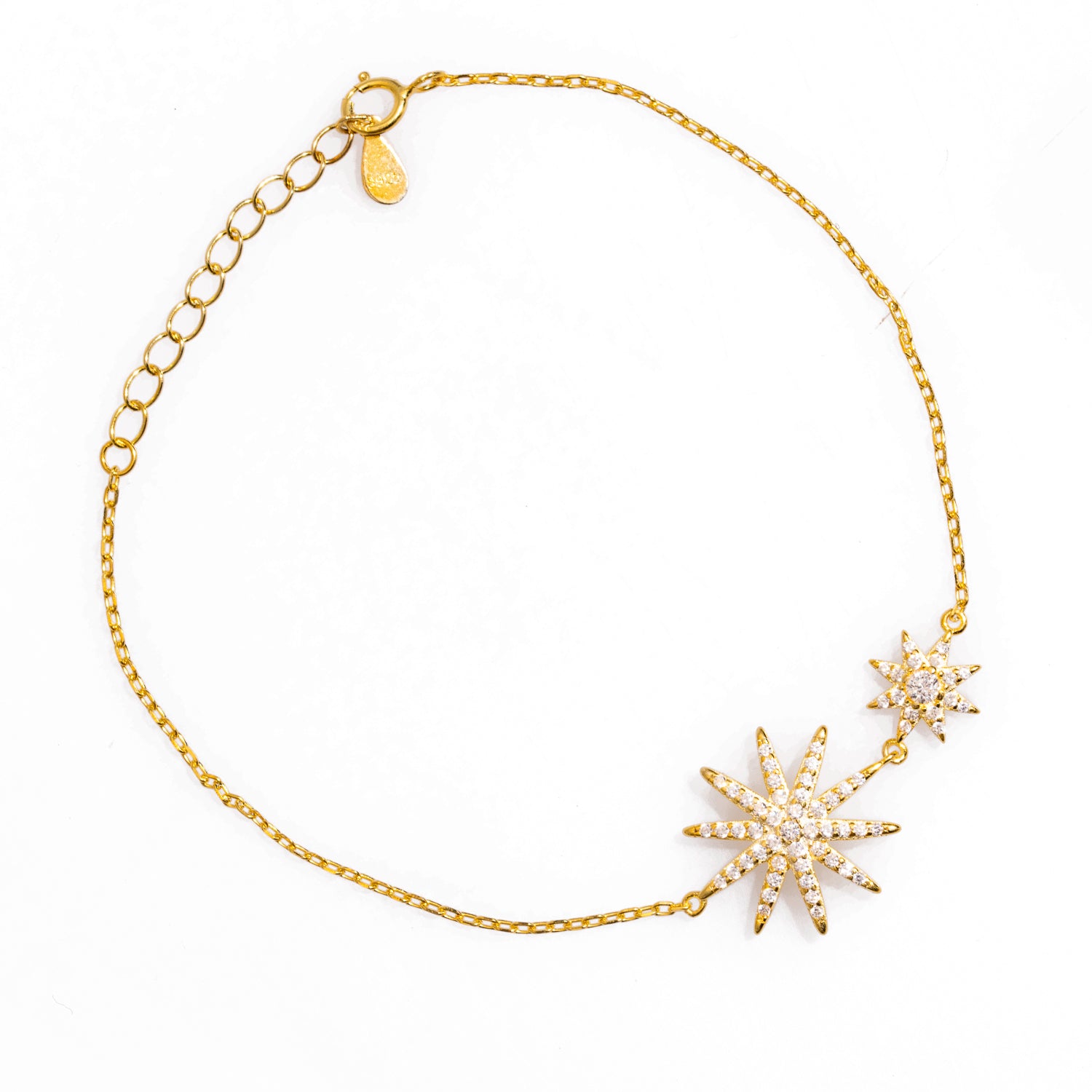 Celestial star bracelet with gold plating and diamond accents, featuring adjustable length for versatile wear.