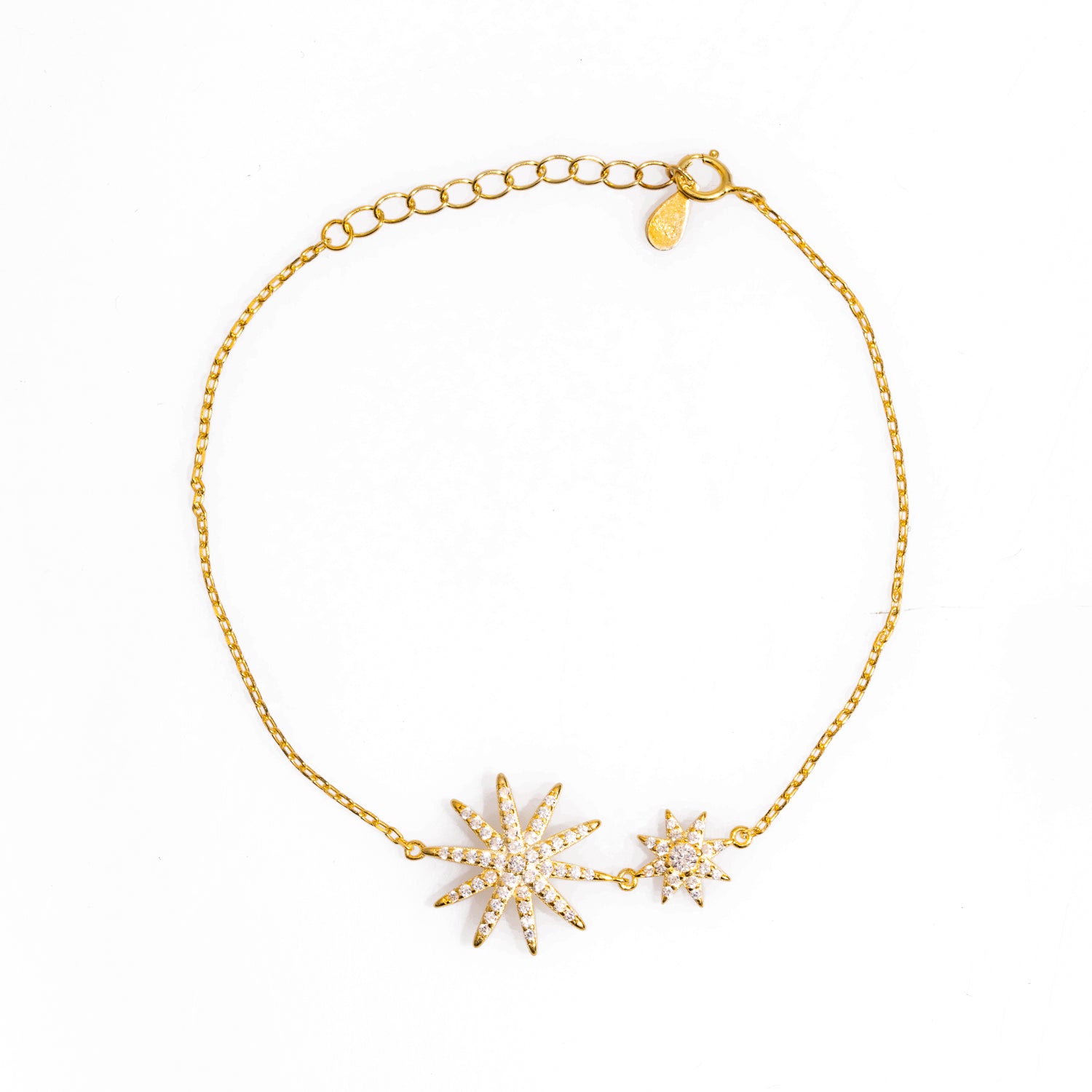 Elegant gold-plated sterling silver bracelet featuring a large and a small star charm, each embellished with sparkling CZ diamonds.