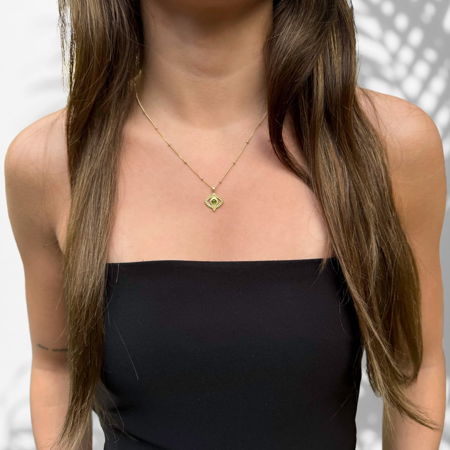 Captivating Beauty: Model Wearing Gold Chain with Tourmaline Pendant