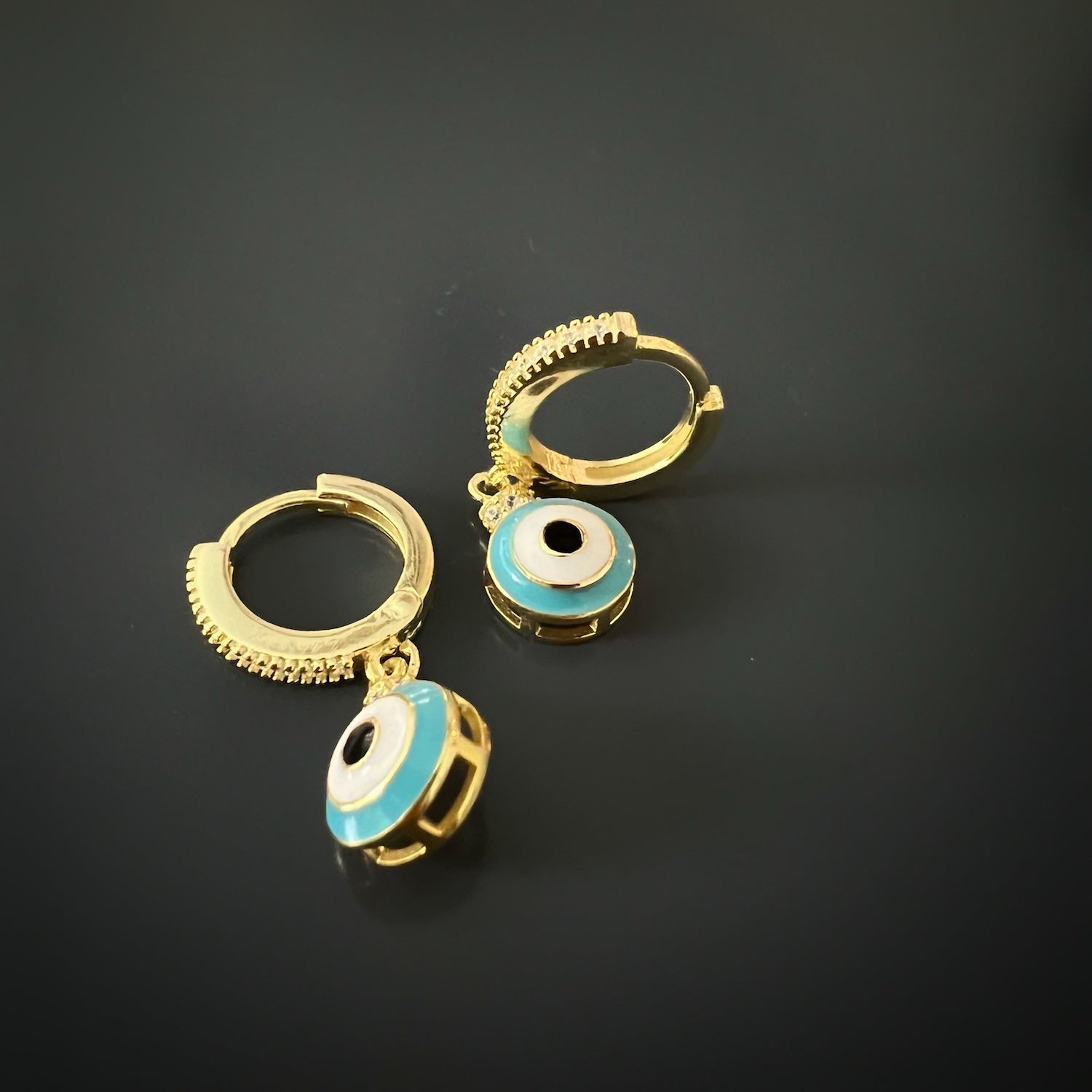 Handcrafted gold earrings featuring a beautiful turquoise evil eye design