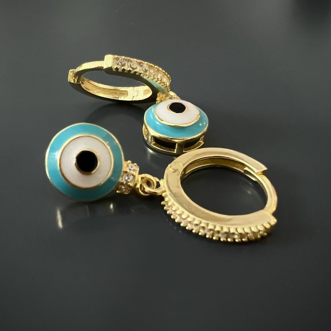 Gold-plated earrings with a symbolic turquoise evil eye charm
