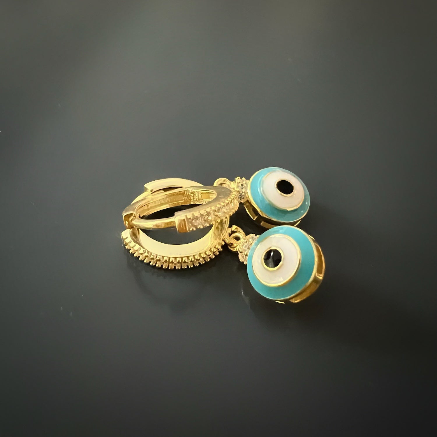 Stylish and meaningful earrings designed with turquoise enamel and zircon stones