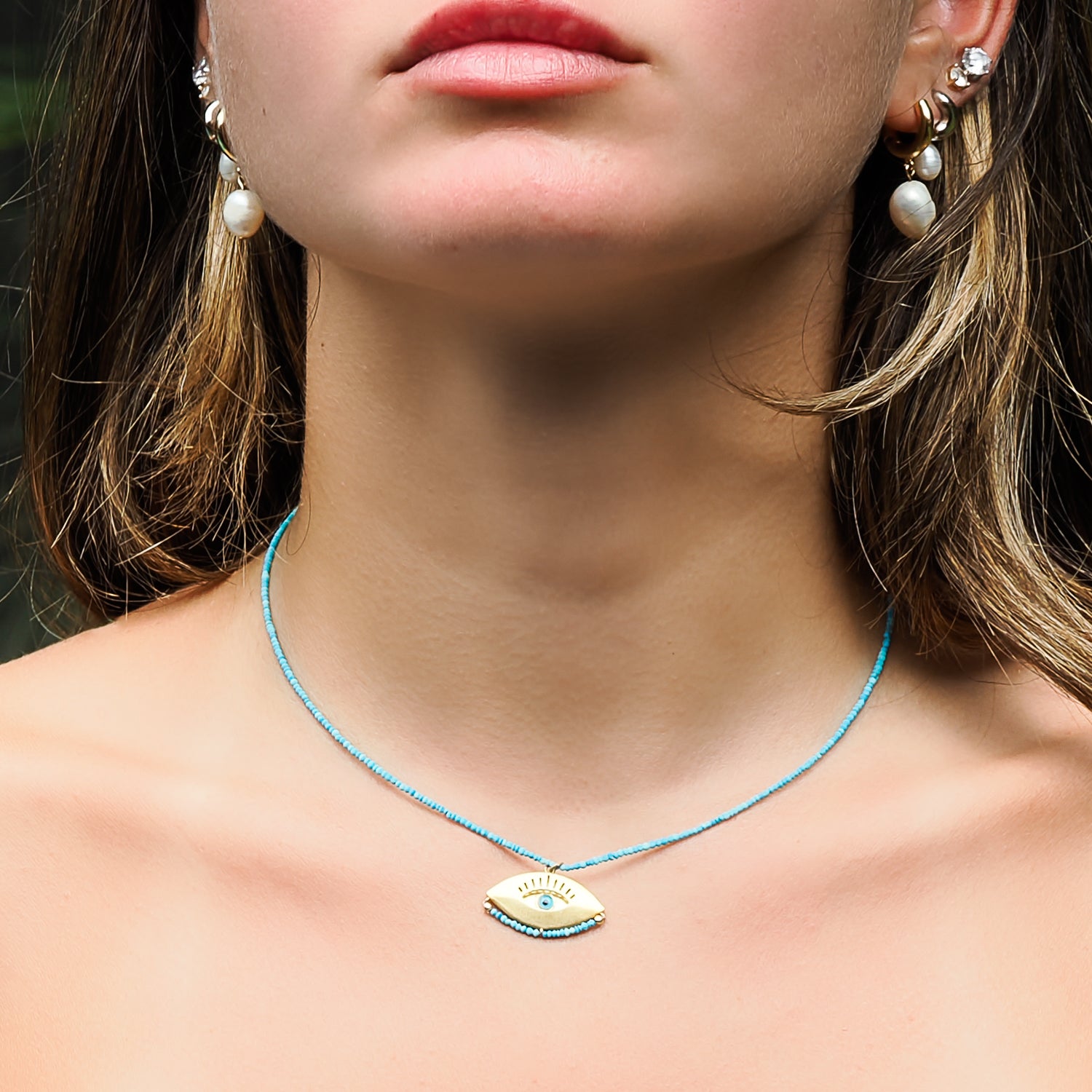 Model Embraces Protection with Turquoise Evil Eye Necklace.