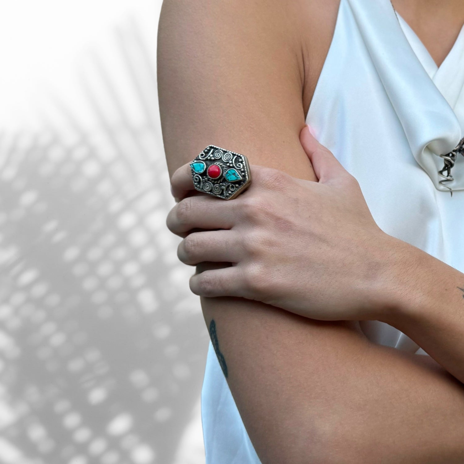 Bold silver ring featuring a spiral design with turquoise and coral gemstones, bohemian and chunky