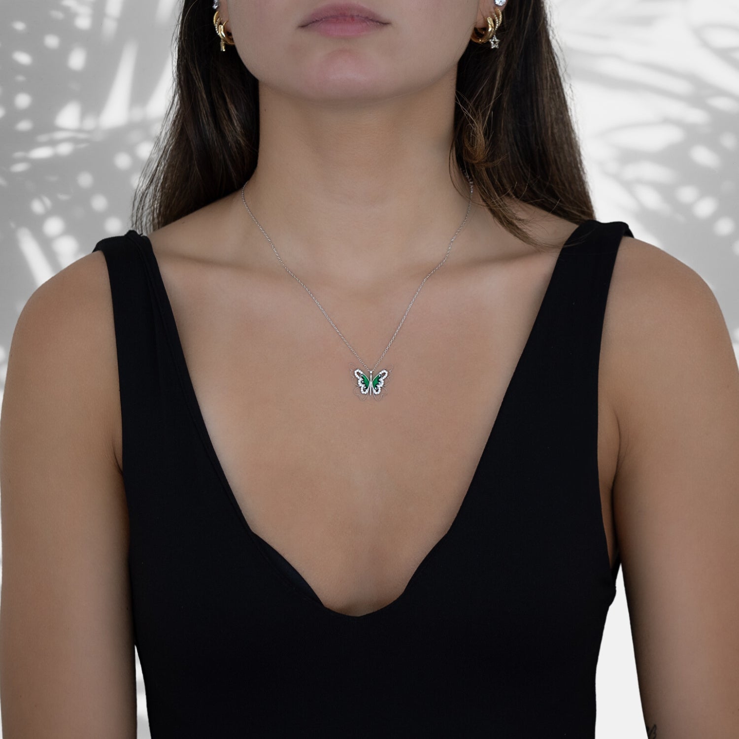 The Abundance Green Butterfly Necklace complementing the model&#39;s style with grace and beauty.