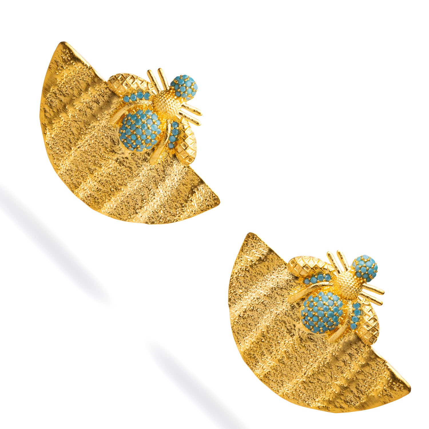 Statement earrings featuring a gold half-moon plate with turquoise stones and a honey bee motif, designed to embrace abundance and style.
