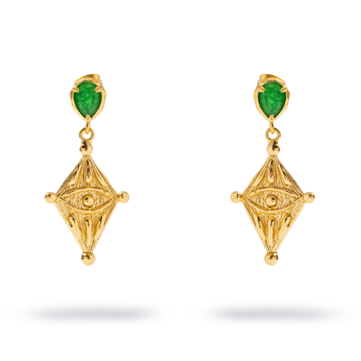 Close view of the Ancient Gaze earrings showing the textured gold kite tablet and its carved watchful eye