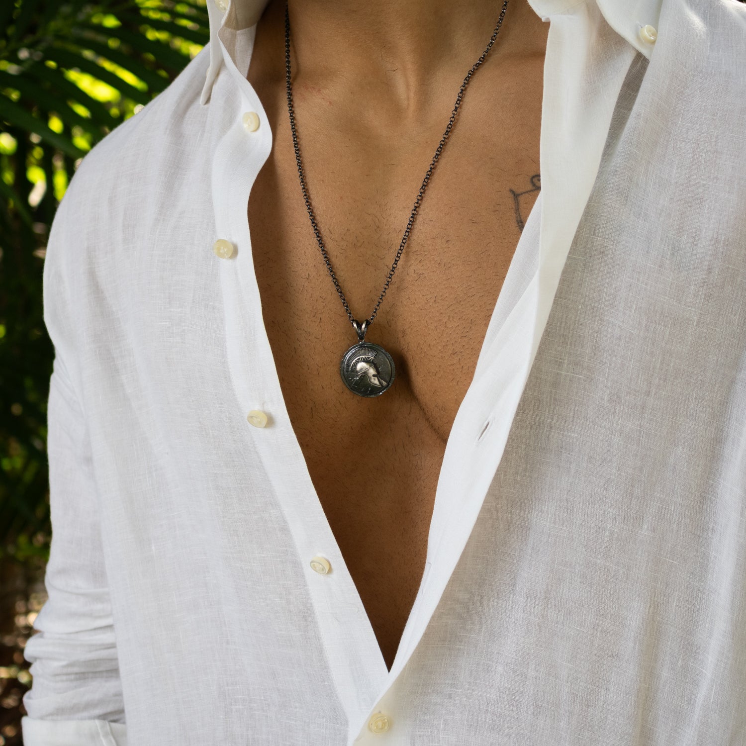 Sterling silver necklace with ancient warrior helmet medallion pendant, rhodium finish, antique texture, strong chain, bold symbolic masculine style.