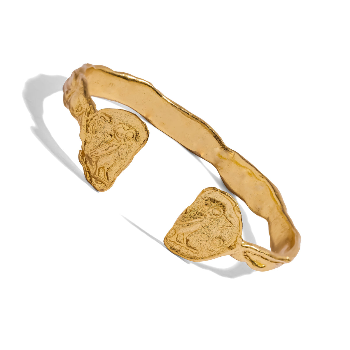 Angled view of the 24K gold plated brass owl coin cuff showing the molten hammered band