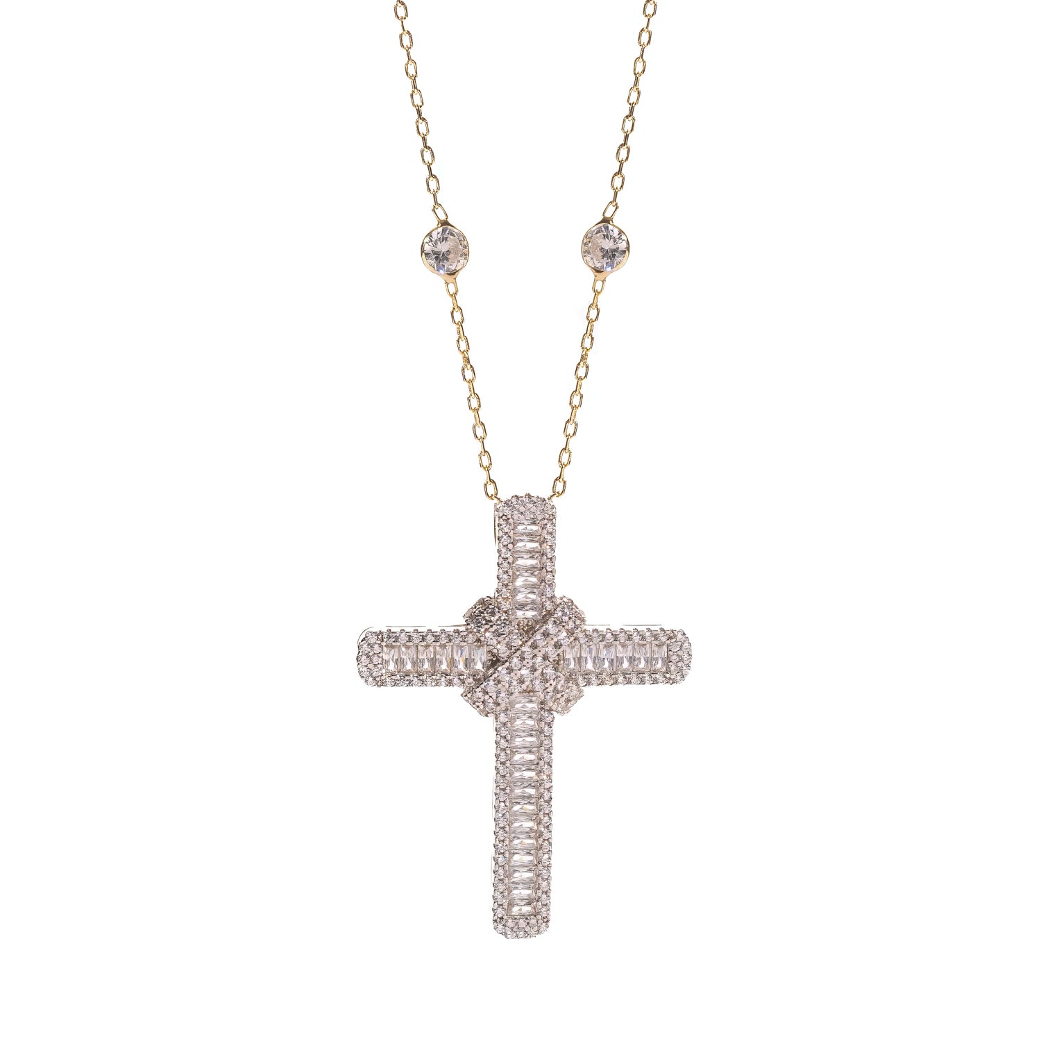 Close up of the baguette cubic zirconia cross pendant and gold bezel set station chain