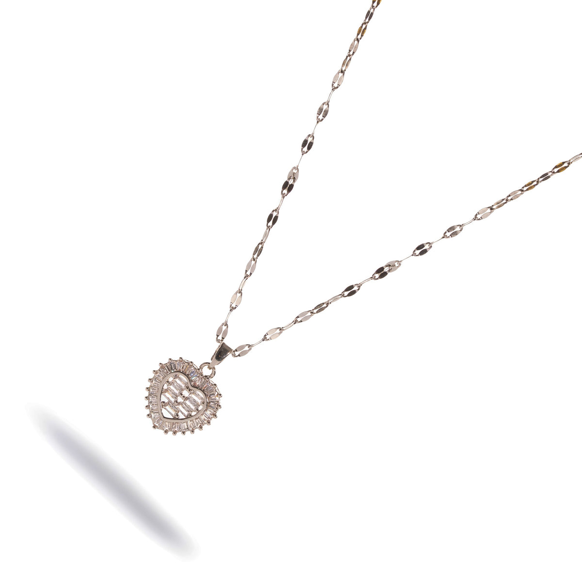 Angled view of the baguette diamond halo heart necklace on a white background