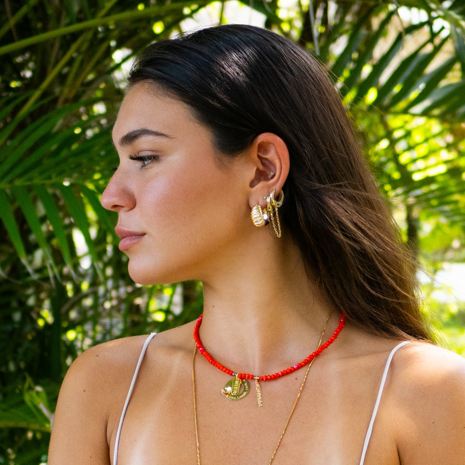 Handmade red crystal choker with “Believe” and “Be Happy” engraved gold pendants.

