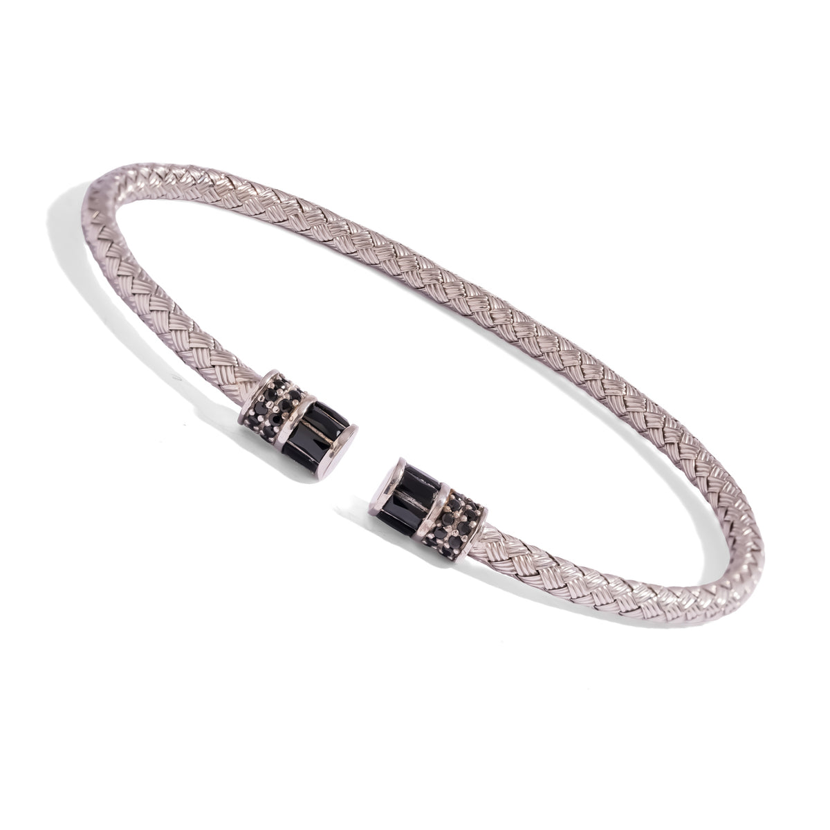 Angled view of the open woven silver cuff showing both black barrel end caps