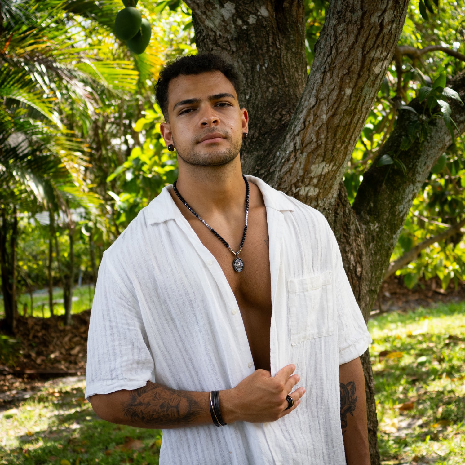 Bold men's necklace featuring 6mm black onyx beads and a detailed solid silver lion head pendant.

