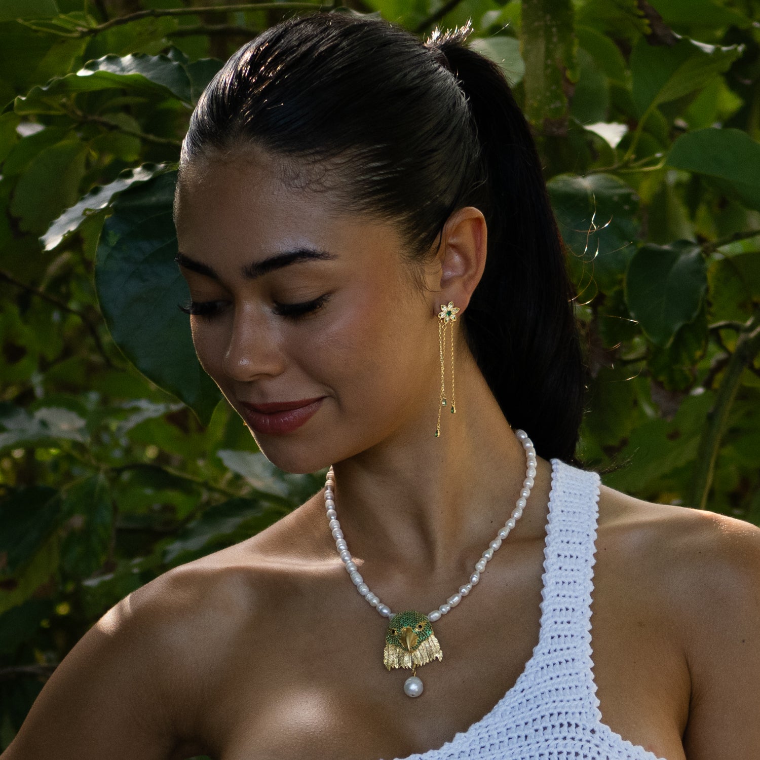 18k gold vermeil drop earrings with green emerald stones, floral-inspired design, and delicate gold chain accents.