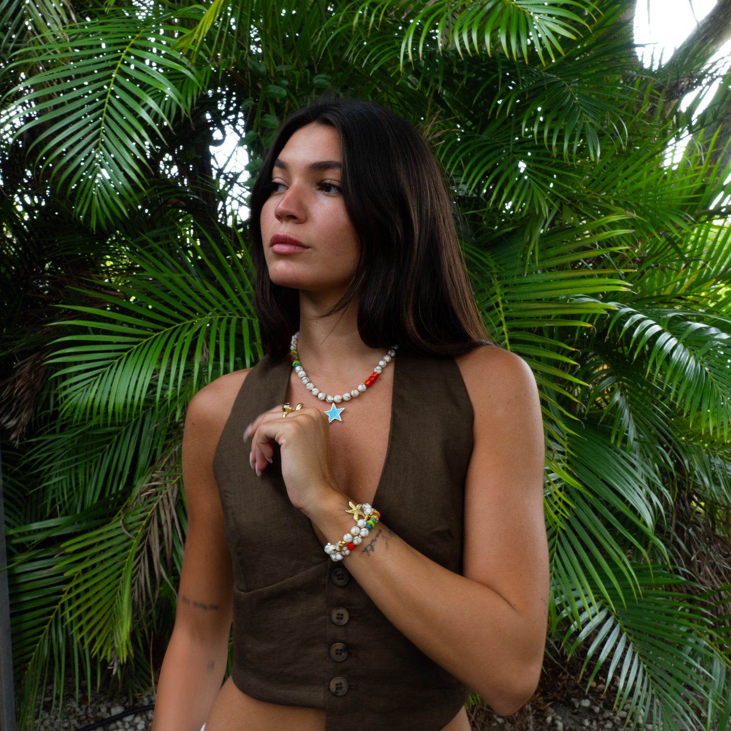 Detail of blue star Tibetan agate choker styled with beaded starfish bracelets