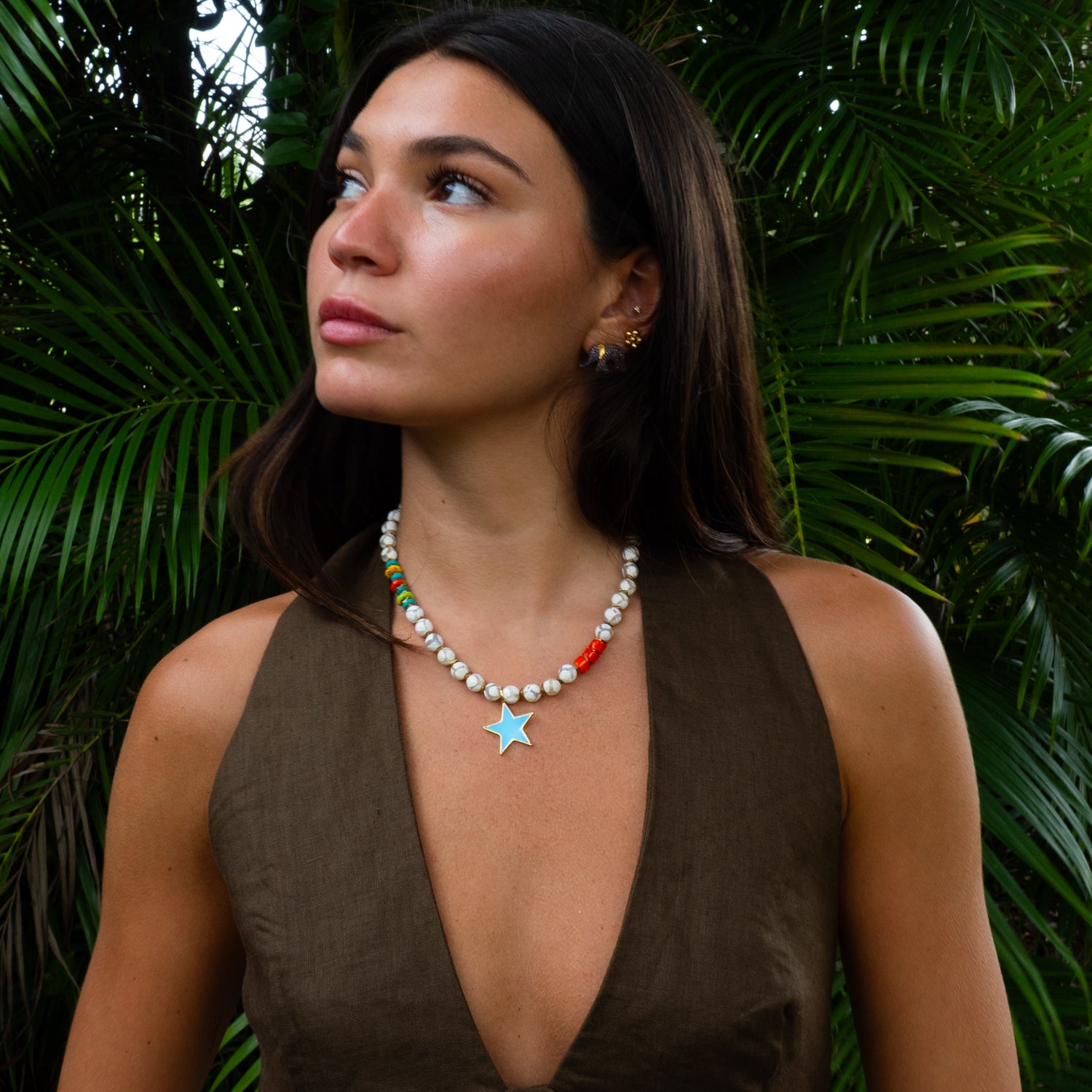 Woman wearing blue star agate choker necklace with brown linen top