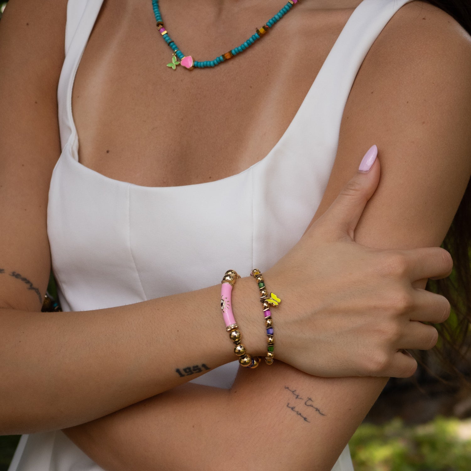 Wrist view of Butterfly Pink Evil Eye bracelet set for joyful and modern elegance

