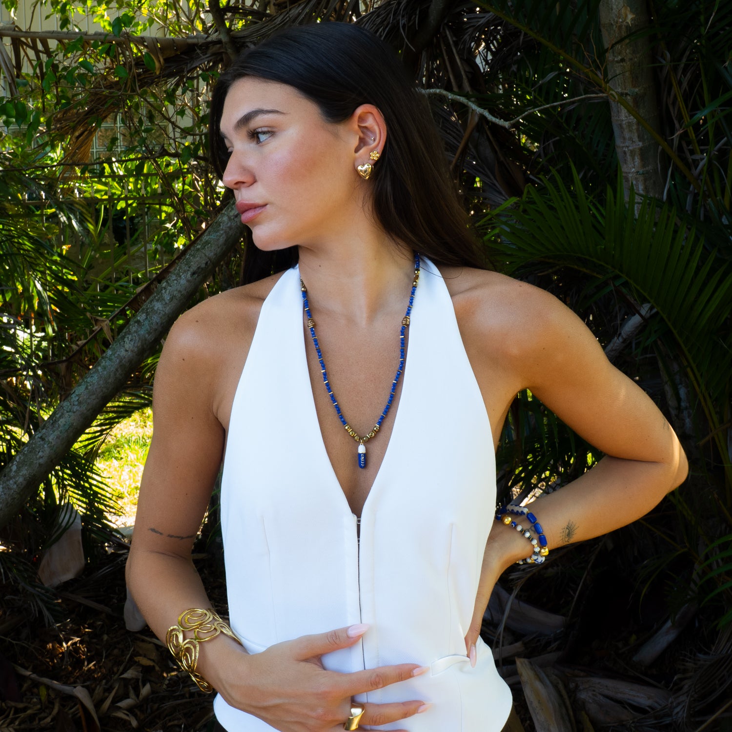 Model styling Chill Pill beaded blue necklace with white linen halter, summer mantra jewelry