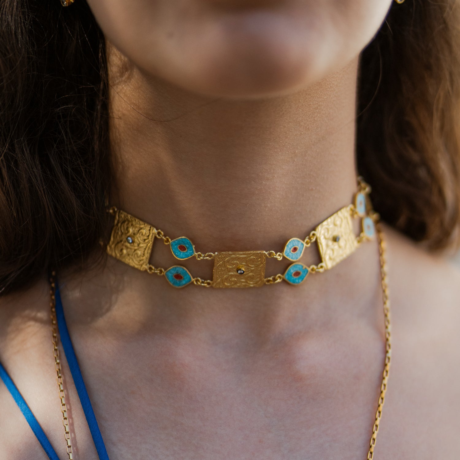Cleopatra Evil Eye Turquoise &amp; Coral Engraved Gold Collar Necklace worn close on the collarbone, gold plaques and turquoise eyes across the neckline