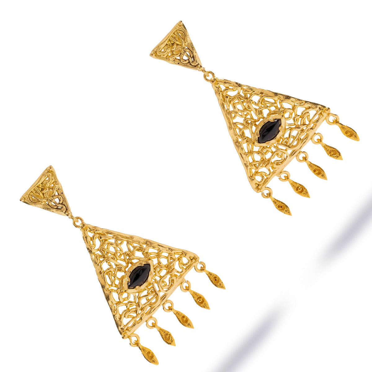 Three quarter studio view of the filigree triangles, the openwork gold reading as lace around the black onyx