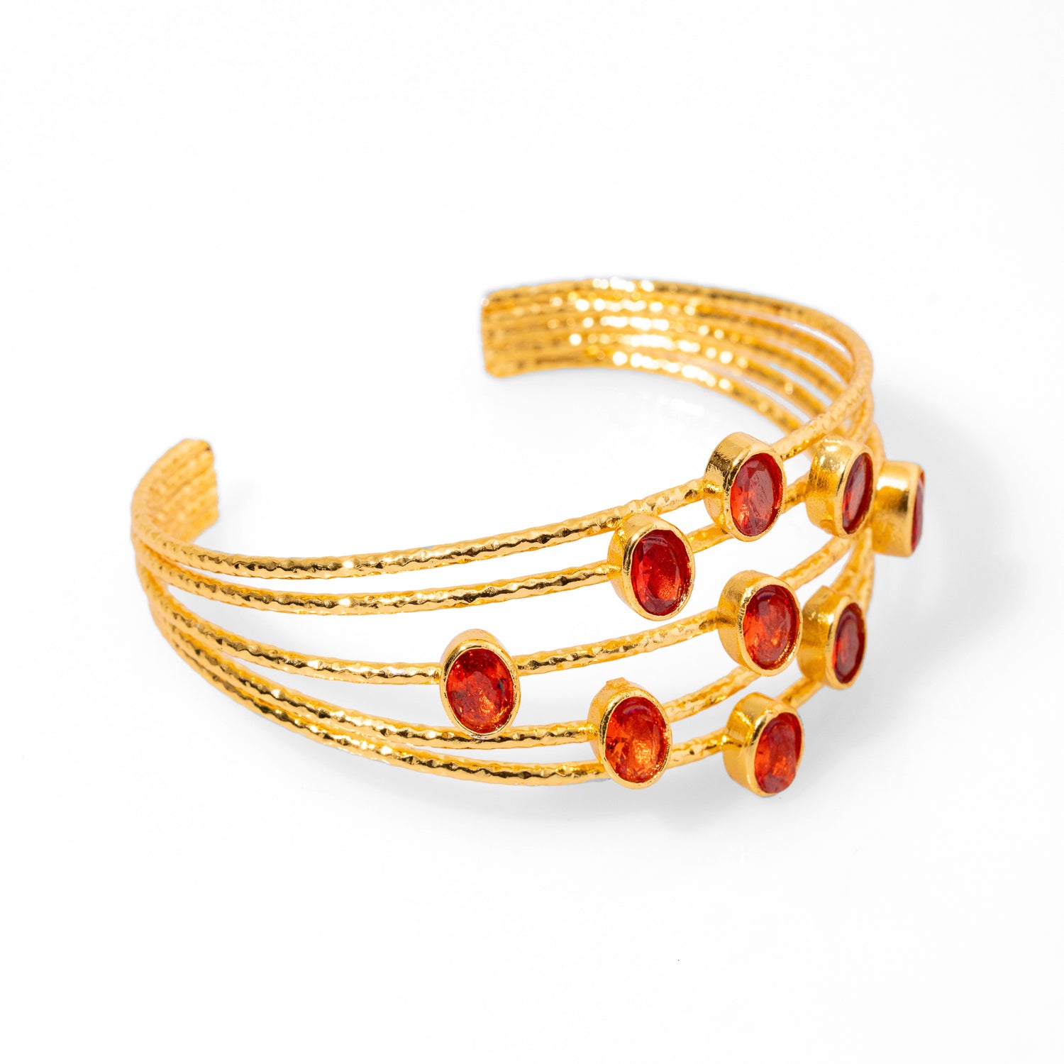 Sophisticated chunky cuff bracelet with 24k gold plating and carnelian stones, designed with five gold wires, adjustable fit.
