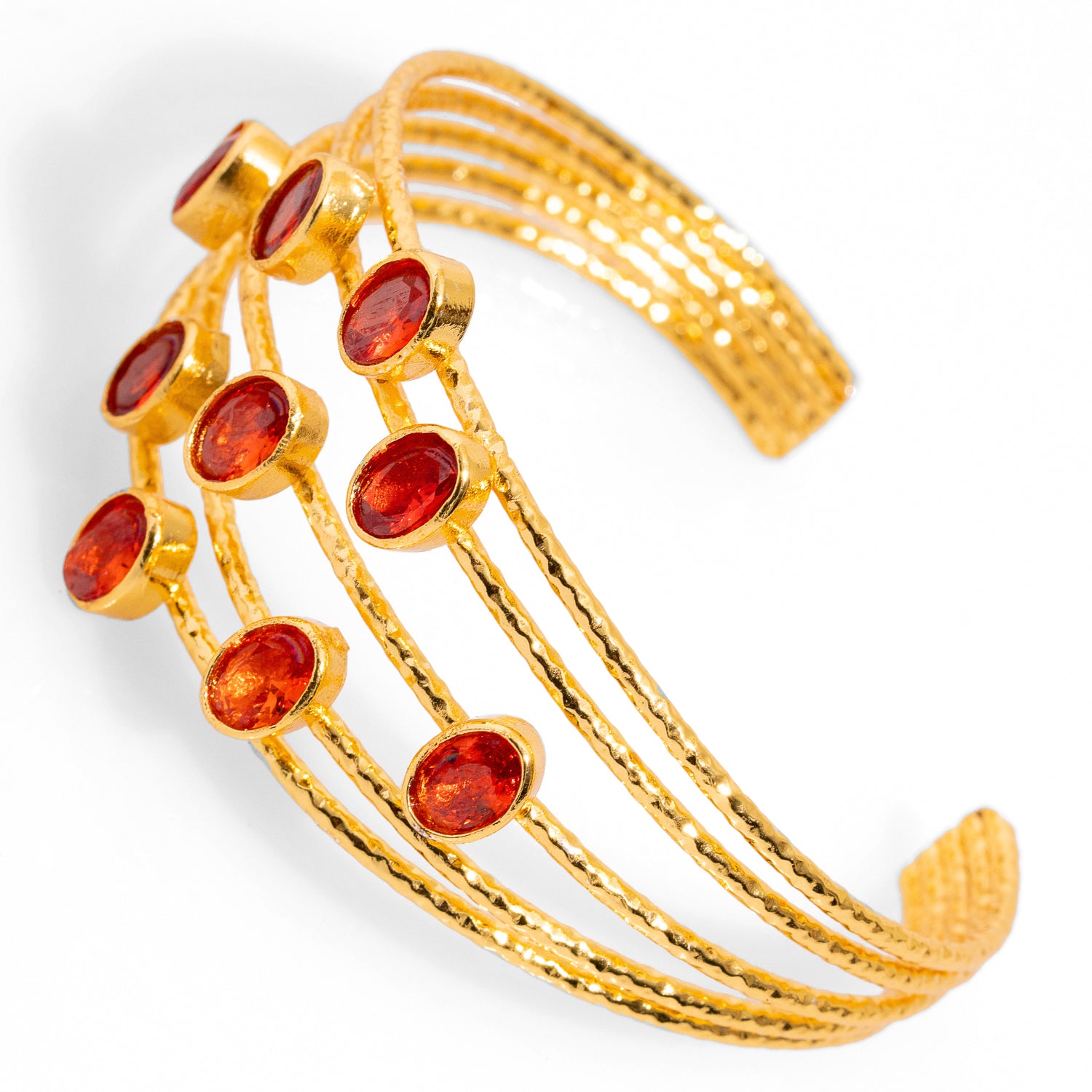 Refined gold cuff bracelet with 24k plating, incorporating oval carnelian stones and five gold wires, adjustable for a perfect fit.
