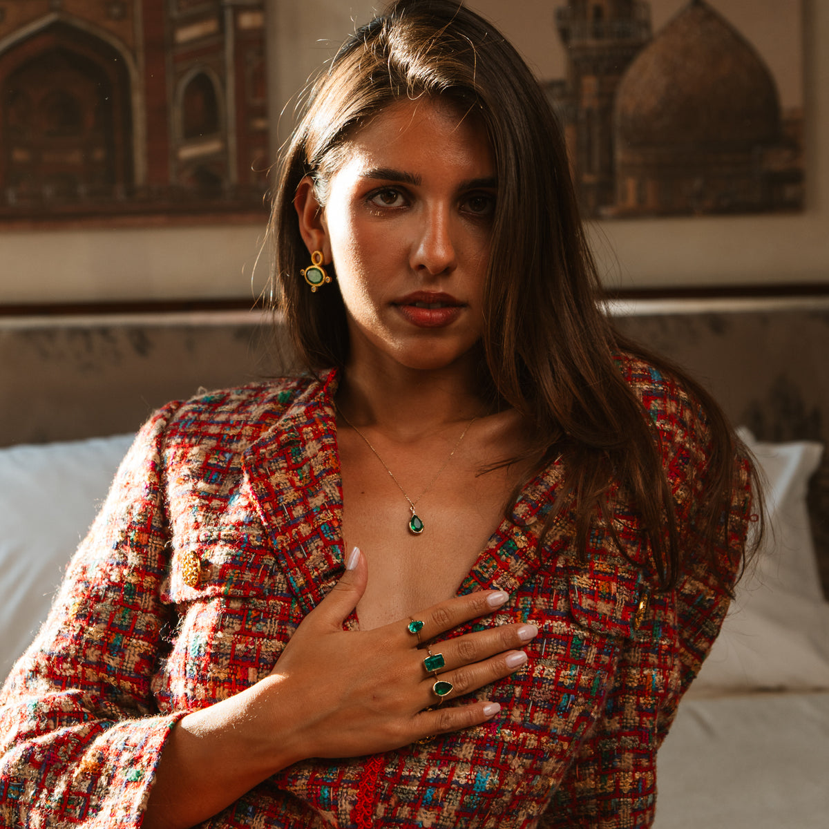 Model wearing the Cleopatra Green Cat Eye earrings with a green teardrop pendant and green stone rings
