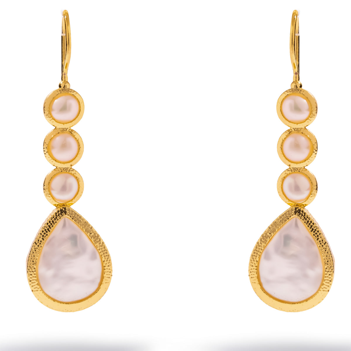 Close studio view of the Cleopatra pearl drop earrings showing the hammered texture of the gold frame around each pearl