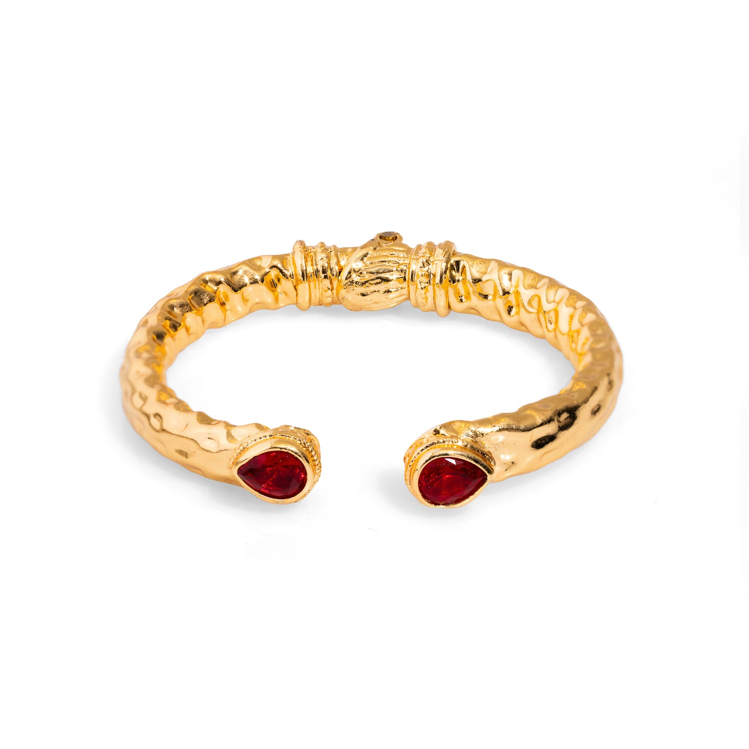 Luxurious chunky cuff bracelet featuring teardrop-shaped ruby stones and 24k gold-plated brass, inspired by the beauty and power of Cleopatra.
