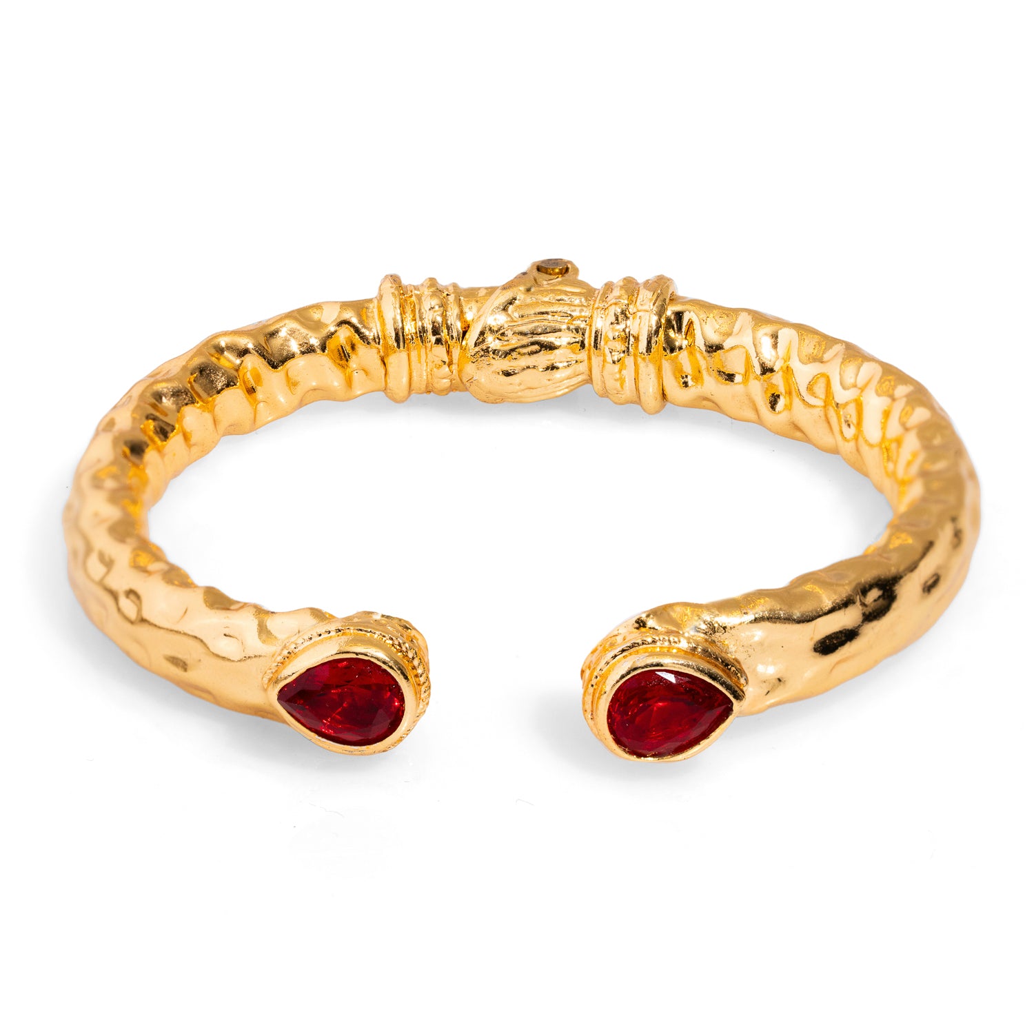 Alluring chunky cuff bracelet featuring teardrop ruby stones set in luxurious 24k gold-plated brass, offering a regal touch inspired by Cleopatra.
