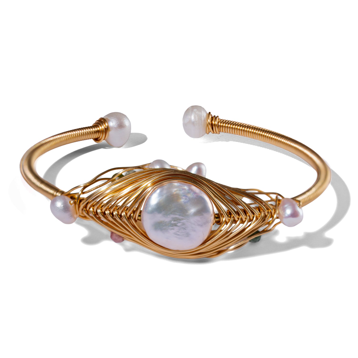 Cleopatra’s Eye open cuff bracelet with a central baroque pearl wrapped in sculptural 18K gold-plated wire in an eye-shaped design.
