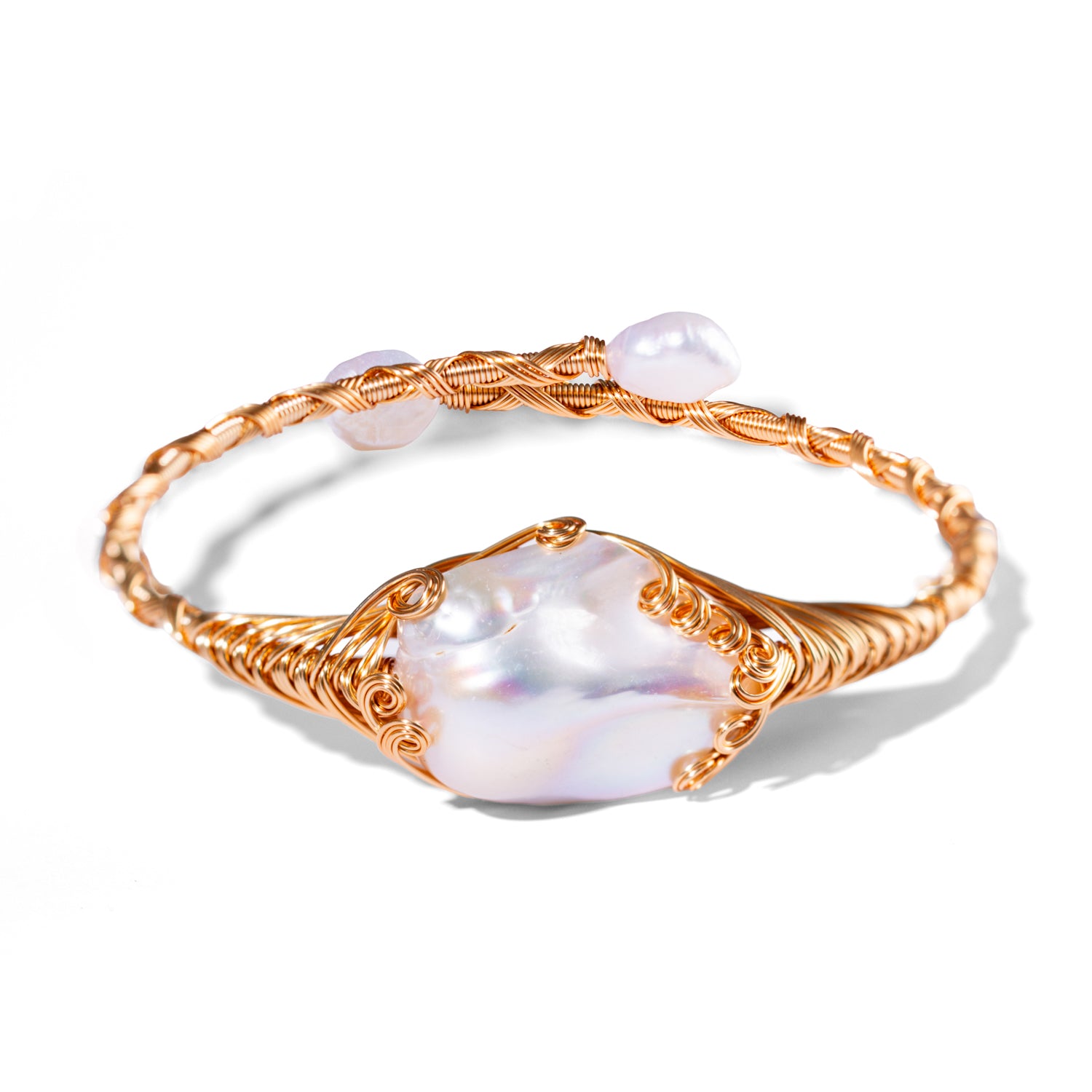 Cleopatra’s Treasure open cuff bracelet with a large baroque pearl and small gold beads on an 18K gold-plated adjustable band.
