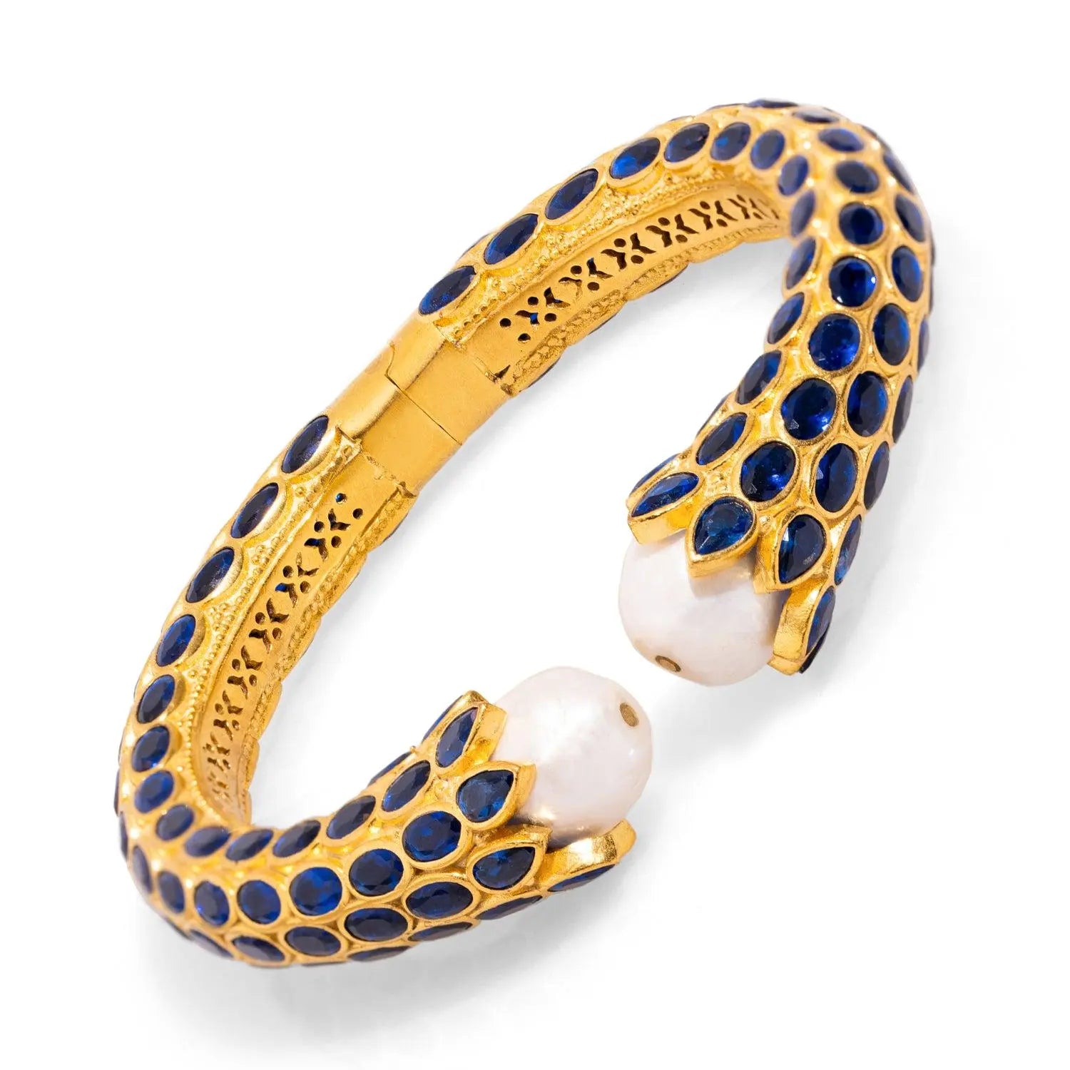 Luxurious handmade gold cuff bracelet with sapphire and pearl details, perfect for evening wear.