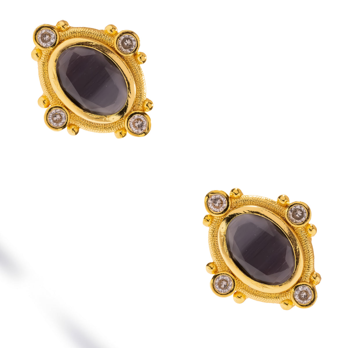 Pair of Cleopatra black cat's eye gold stud earrings shown at an angle on white