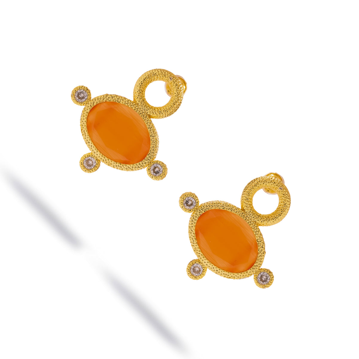 Cleopatra Sun Cat Eye Gold Statement Earrings at an angle, showing the textured gold bezel and zircon settings