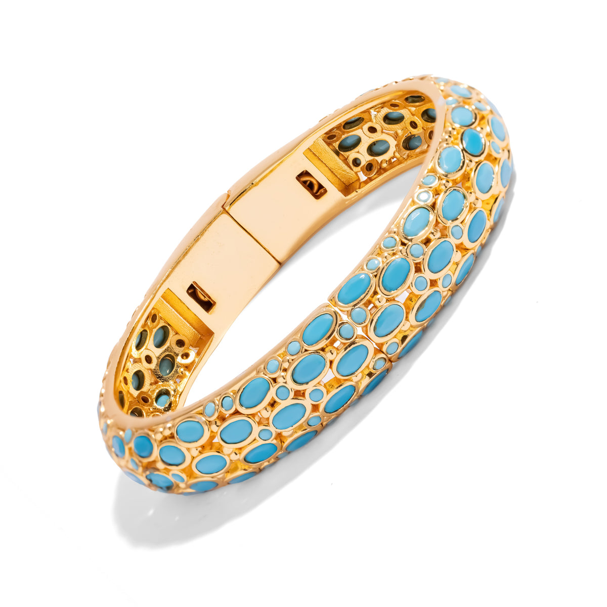 Domed gold bangle covered in oval and round turquoise cabochons, side view on white