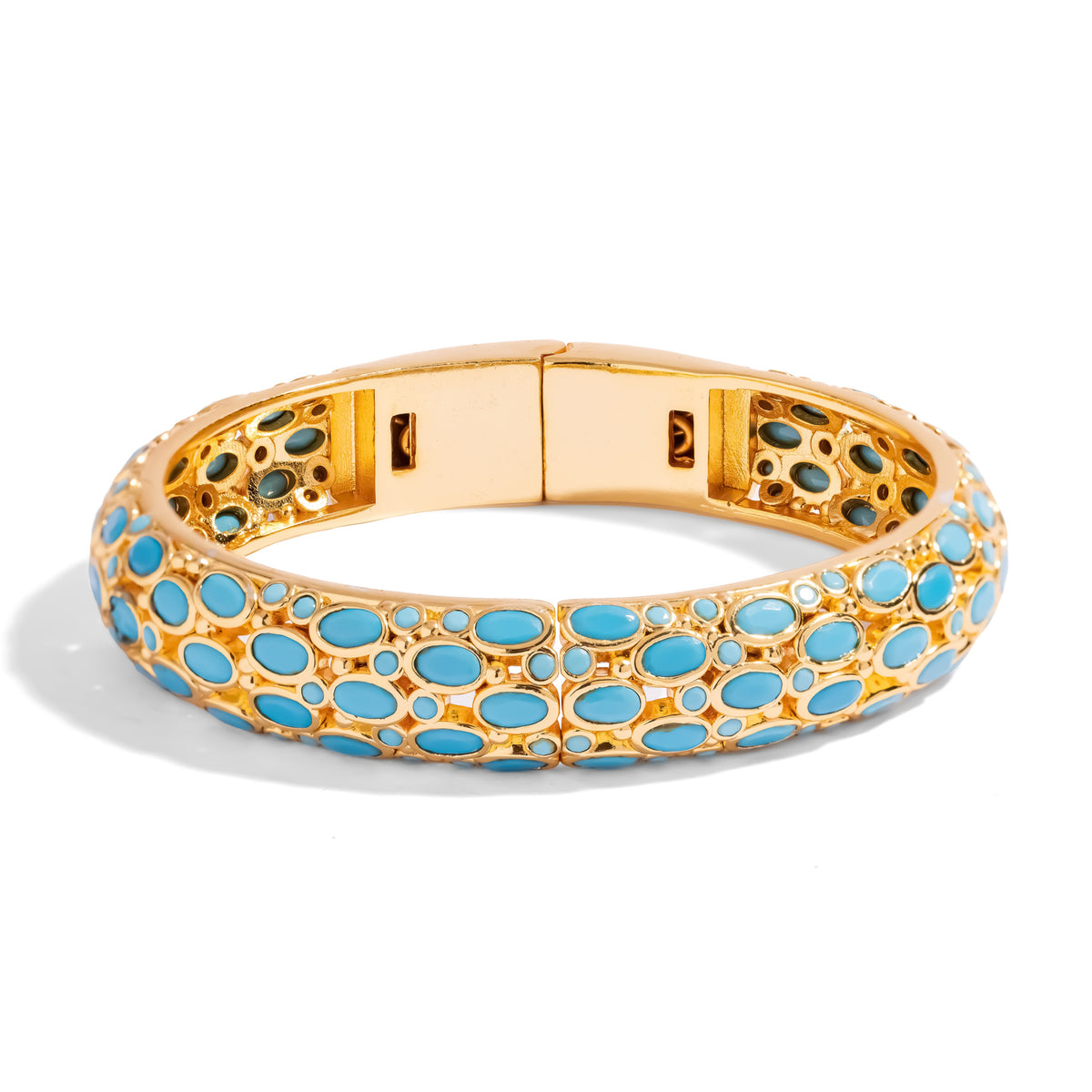 Front view of the turquoise cabochon gold bangle bracelet with its hinge open slightly at the back