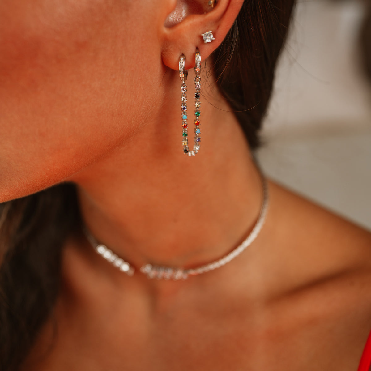Close up of the Color Story Gemstone Sterling Silver Drop Earrings on the ear with the Marquise Cubic Zirconia Woven Sterling Silver Choker Necklace