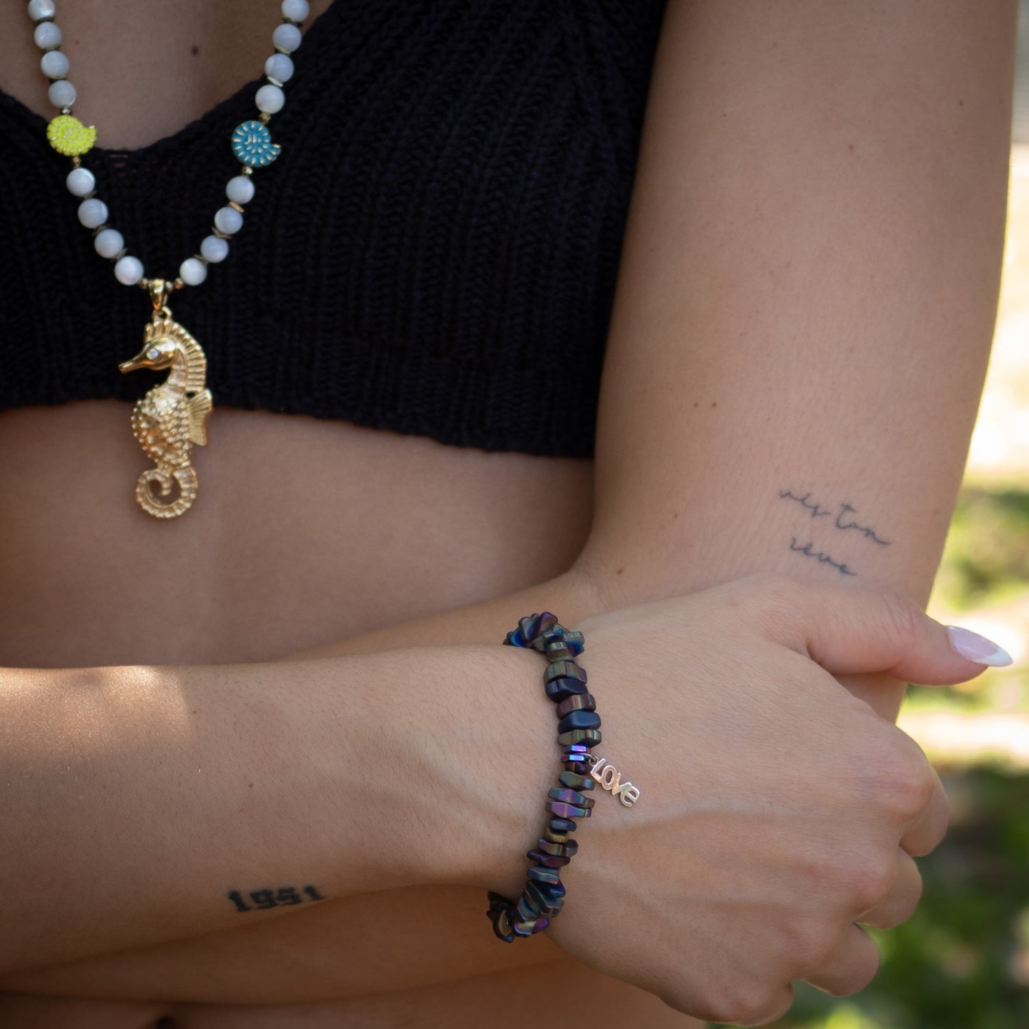 Handmade stretch bracelet featuring multi-color nugget hematite beads and sterling silver LOVE charm


