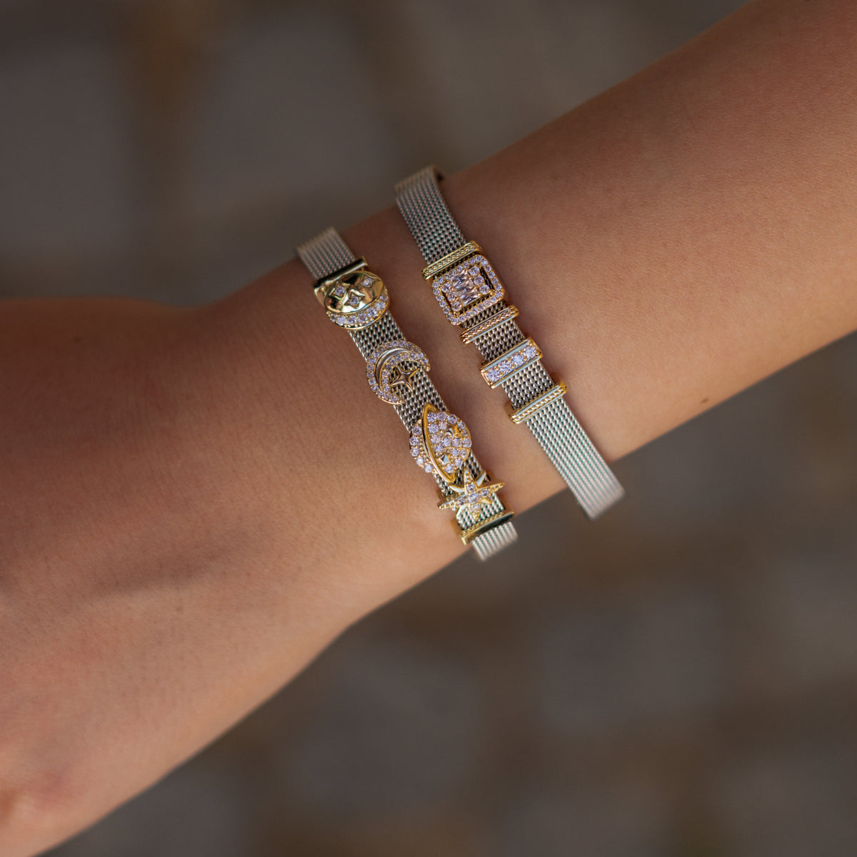 Cosmic Guidance moon and star charm bracelet stacked with the Baguette Diamond Halo Silver Charm Bracelet on the wrist