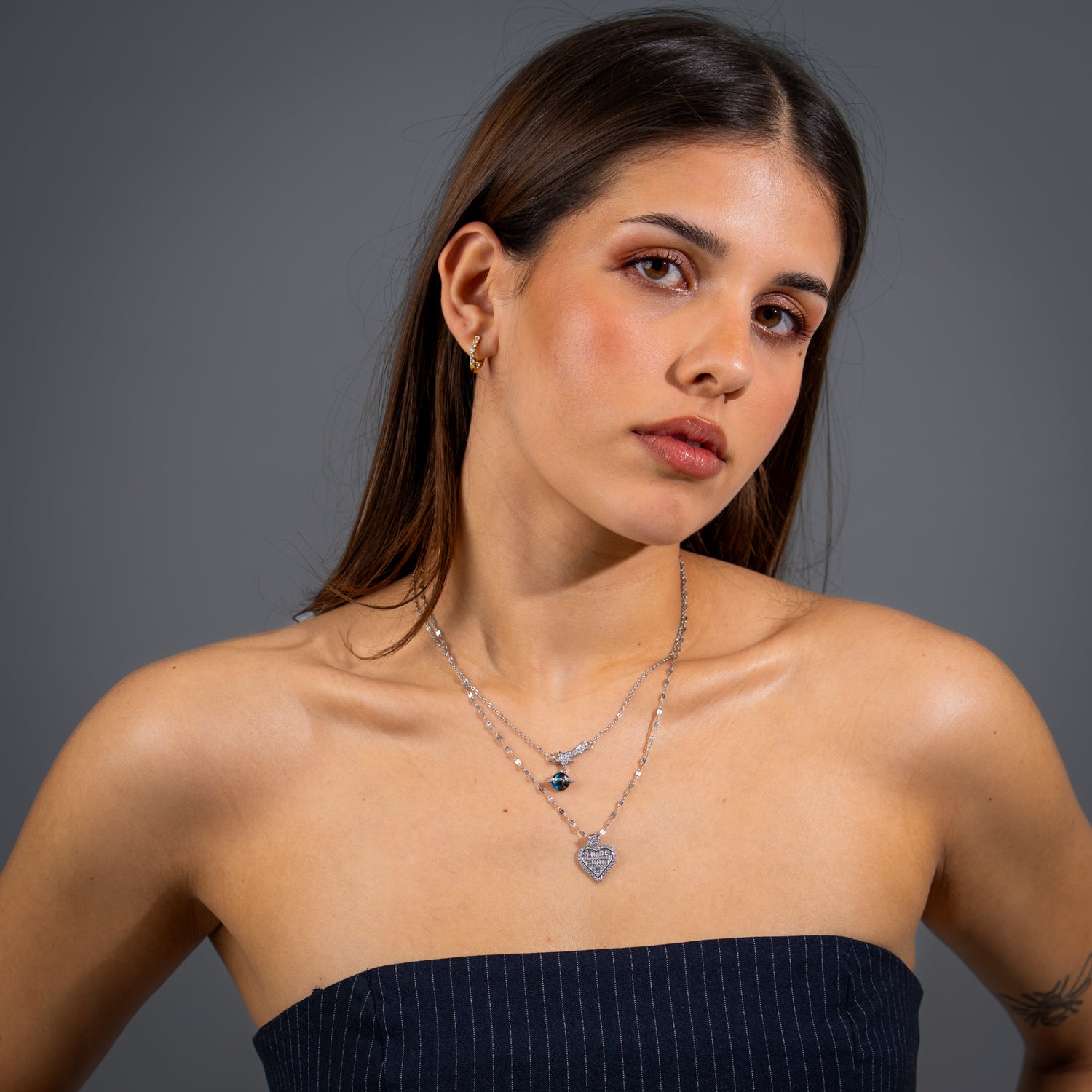 Silver star drop necklace with round blue opal accent on a delicate silver chain.

