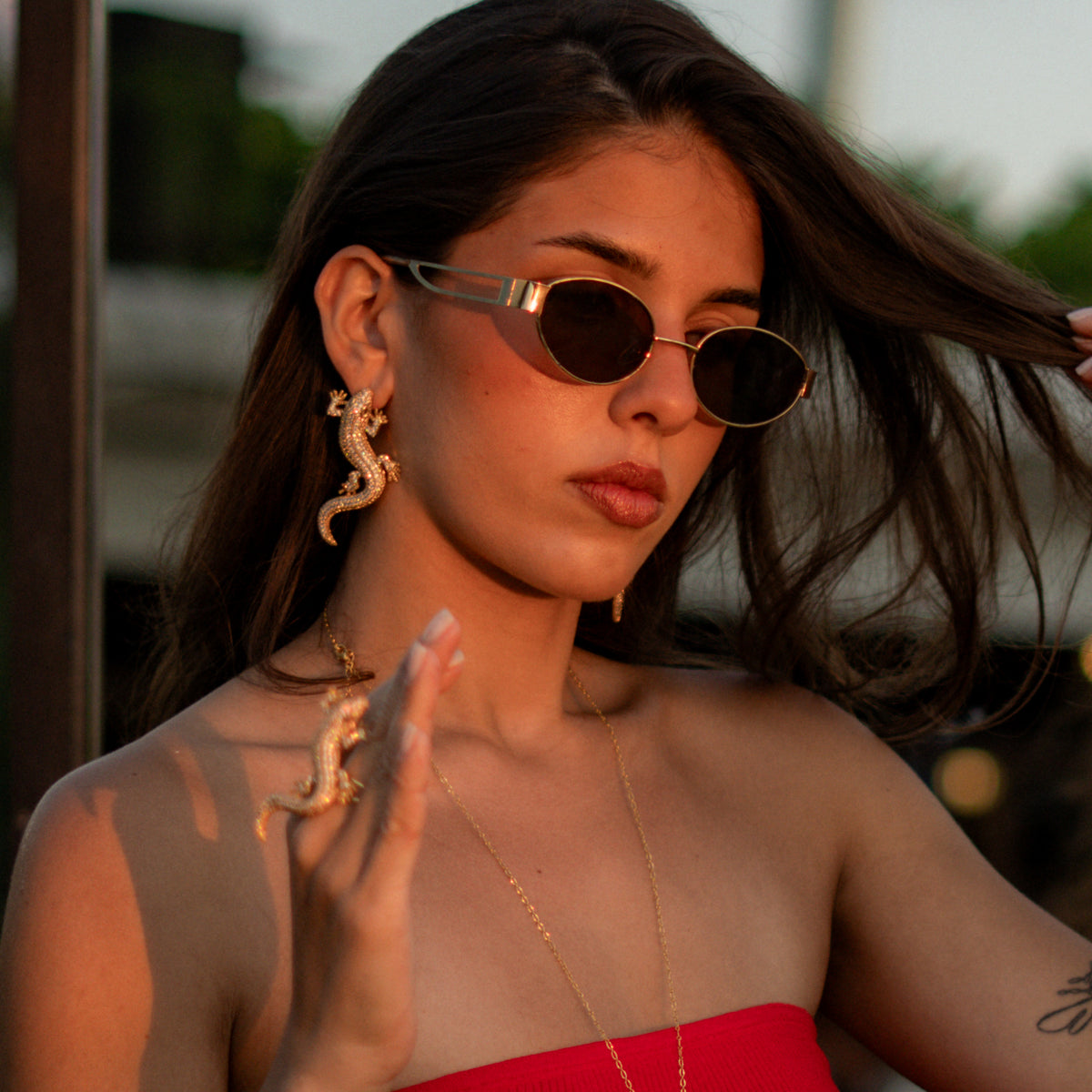 Crocodile Pave Zircon Gold Statement Earrings worn on the ear with the matching crocodile ring on the hand