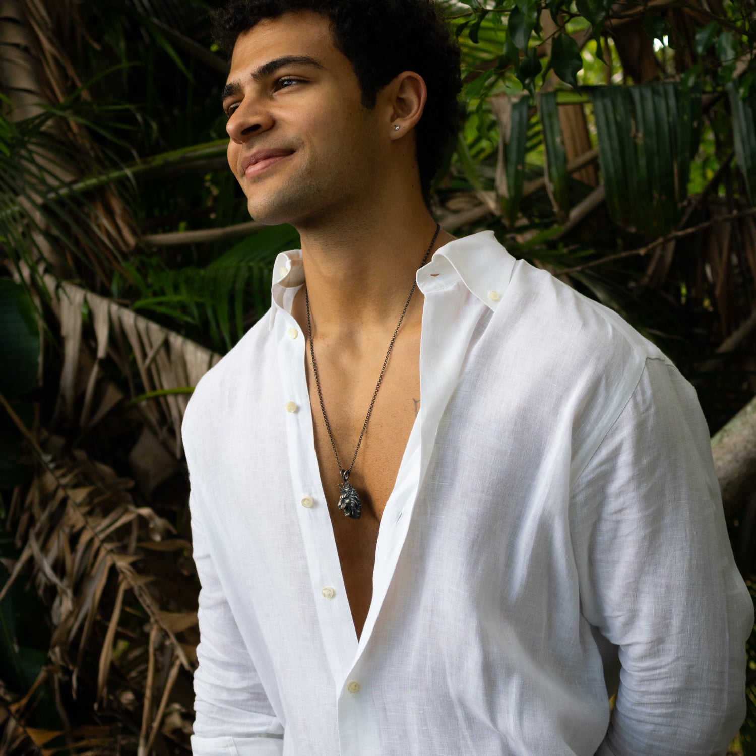 Sterling silver necklace with crowned lion head pendant, rhodium finish, black and silver accents, regal and bold masculine style.