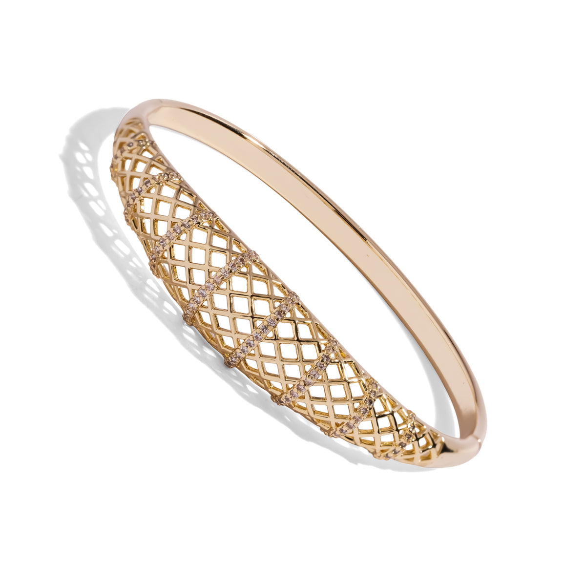 Angled view of the hinged gold lattice bangle showing the slim polished back band