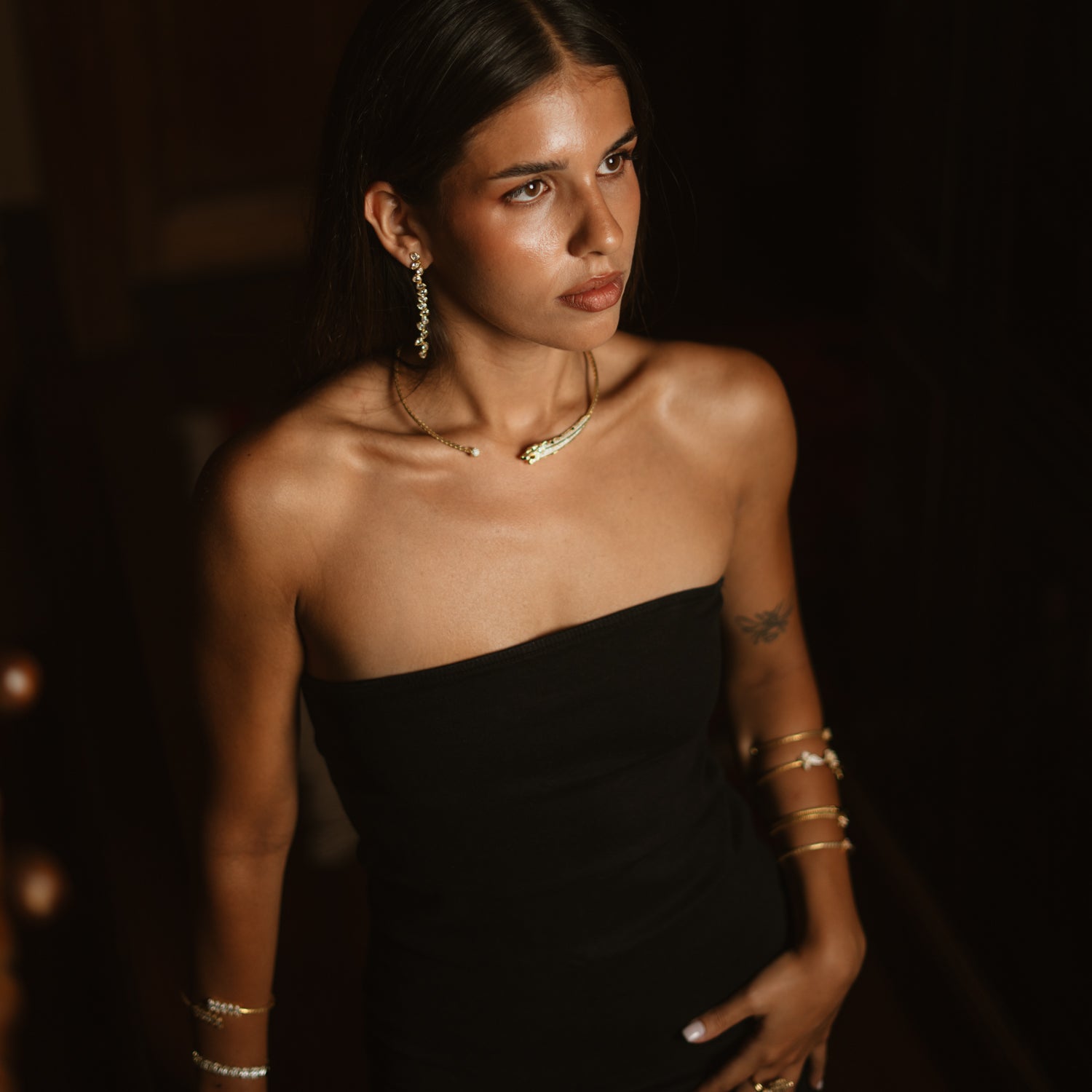 Model in a black strapless dress wearing the Divine Panther Power gold collar necklace