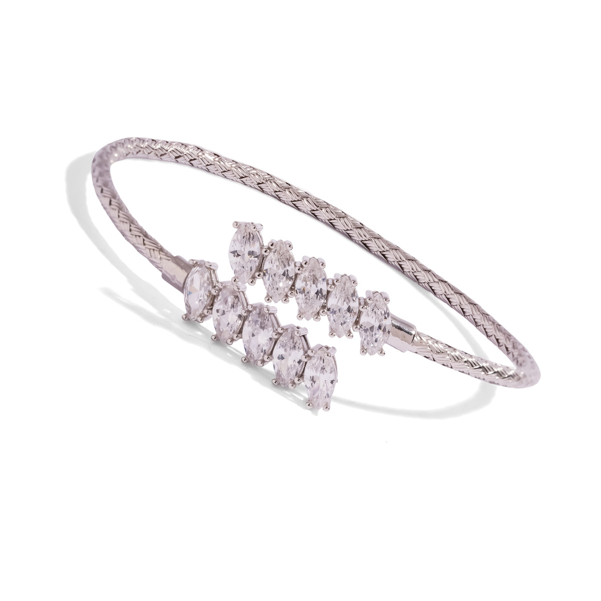 Angled view of the woven sterling silver bypass cuff with prong set white zircon marquise stones