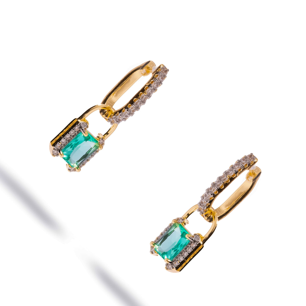 Mint green zirconia gold huggies drop earrings shown at an angle, revealing the pave huggie hoops and padlock shackles