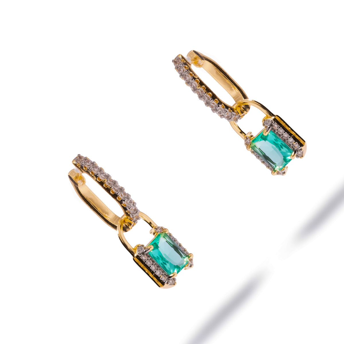 Pair of emerald cut mint green zirconia gold huggie earrings from above, showing the pave edges of the padlock drops