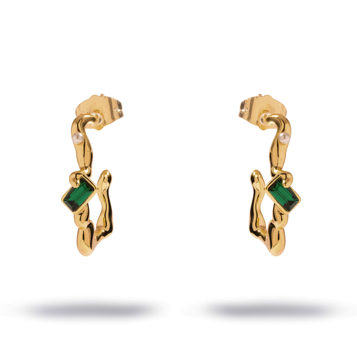 Pair of Emerald Flow gold earrings on white, a molten gold half hoop set with an emerald cut green stone and a tiny pearl